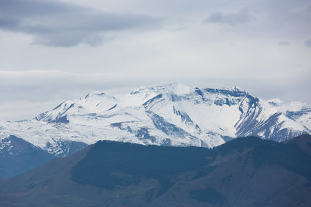 Snow-white mountain peaks. Snowy summits against the sky. Panoramic view of the Caucasian mountains in Dagestan, Russiaの写真素材