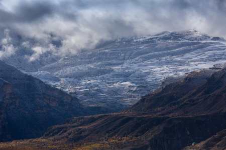Panoramic view from the Gunib village, Dagestan, Russia. Snow capped mountains and autumn fields. Beautiful mountain landscape in winter. View of the villages in the Gunibsky districtの写真素材