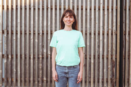 Young female with long hair wears green t-shirt.の写真素材