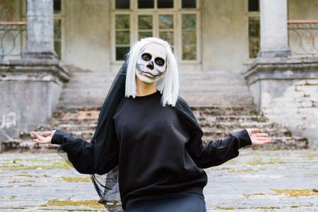 Dead bride is sitting at an old abandoned house.の写真素材