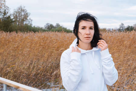 Portrait of a brunette caucasian woman looking at camera.の写真素材