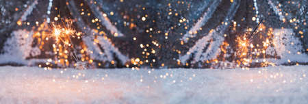 Christmas banner with bengal lights and bokeh. New Year sparklers.