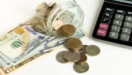 Close up calculator with dollar banknote and coin on bank account background.の写真素材