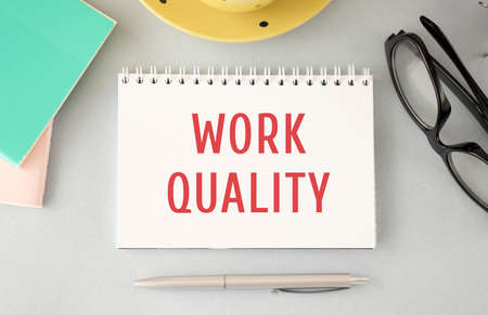 Work Quality - words in open notebook, pen, cup of coffee, top view. Lifestyle success strategy conceptの写真素材