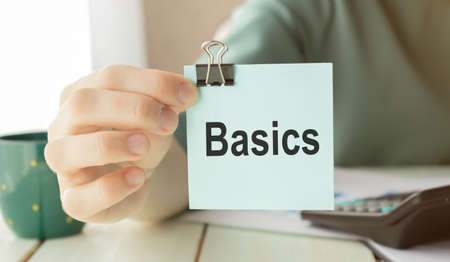 Hand holding an Paper with the word why - BASICS, Business Conceptの写真素材
