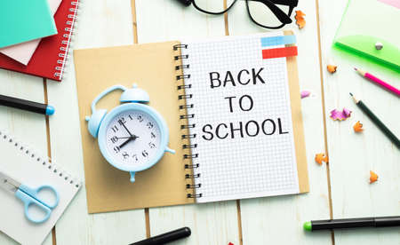 Composite image of students on notepad on desk showing back to school messageの写真素材