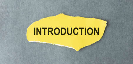 The text Introduction appearing behind torn brown paper.の写真素材