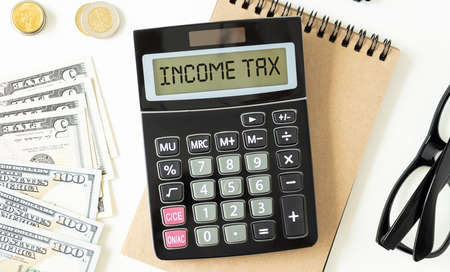 Word Income Tax on calculator. Business and tax concept.の写真素材