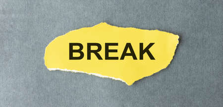 Break text, Inspiration, Motivation and business concept on yellow torn paper.の写真素材