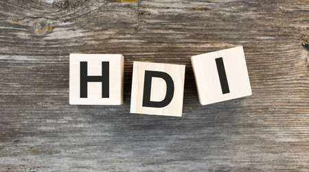 HDI text on wooden block on wooden backgroundの写真素材