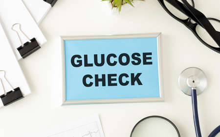 Card with glucose check text message isolated on hospital clinic office background.の写真素材