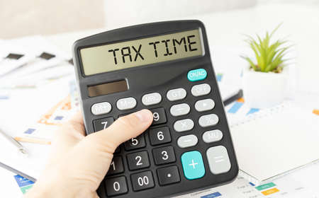 Tax Time word on calculator. Business and tax concept. Time to pay tax in year.の写真素材
