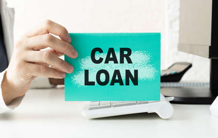 car loan concept with text, calculator and credit card and car key, calculating for debt payment backgroundの写真素材