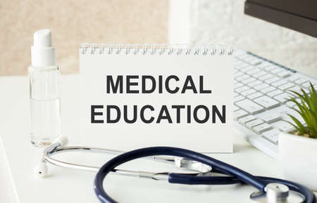 MEDICAL EDUCATION is written on a white piece of paper near the stethoscope. Medical conceptの写真素材