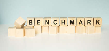 Benchmark word on a wooden cubes on a light backgroundの写真素材
