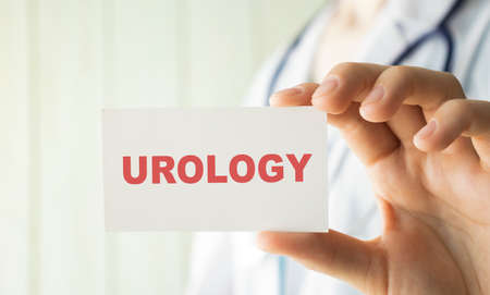 Doctor holding a card with text UROLOGY medical conceptの写真素材