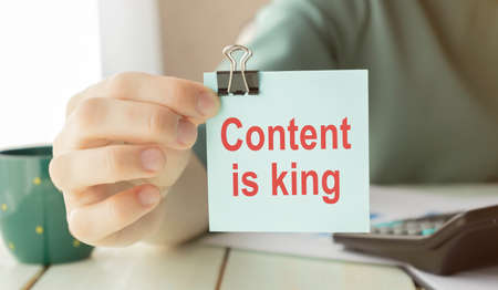 CONTENT IS KING message on the card shown by a manの写真素材