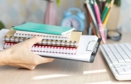 Exams. Cropped view of students writing a test in their exercise books