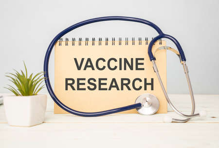 card with text VACCINE RESEARCH medical concept, background and a stethoscope around the text., medical conceptの写真素材