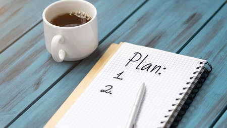 Cookie and cup with coffee, pencil and notebook.の写真素材