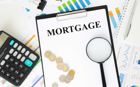 Paper with text Mortgage on a financial tables with glasses. Business and financial conzeptの写真素材