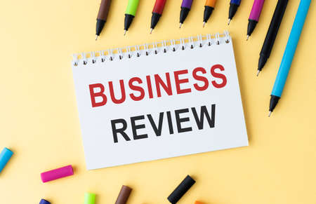 Card with time for Business Review text message isolated on gray wall office background.の写真素材