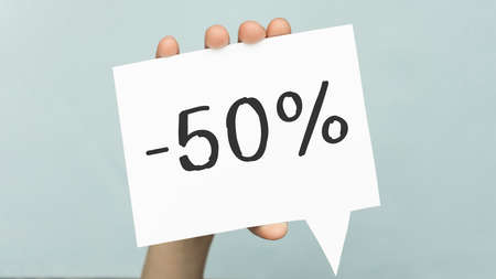 Card in hand with the inscription: -50. Discount concept.の写真素材