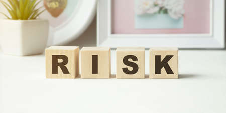 Risk Word On Blocks Arranged Behind The Ruler On Wooden Tableの写真素材