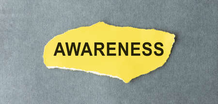 word Awareness written on a yellow piece of paper.の写真素材