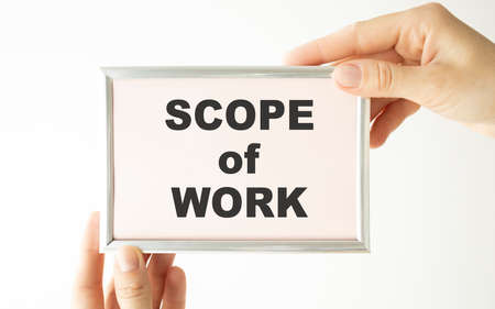 Businessman holding a card with text scope of workの写真素材
