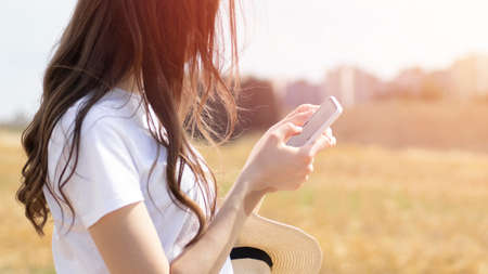 Woman reads message to mobile phone and pointing at screen surprisedの写真素材