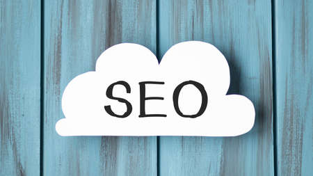 Seo business, search engine optimazion, concept cloud chart. seo text on white paper on the table against the background of a calculator. business concept.の写真素材