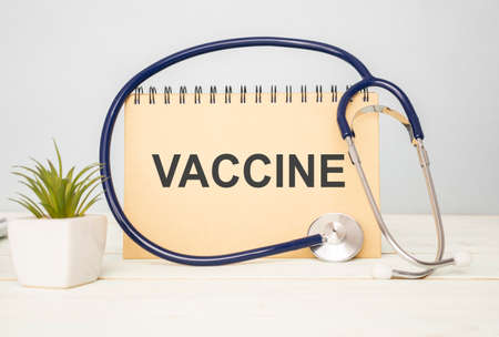 card with text VACCINE medical concept, background and a stethoscope around the text., medical conceptの写真素材