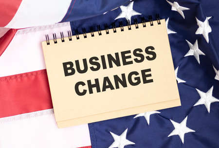text CHANGED BUSINESS written on card lying on american flag, business conceptの写真素材