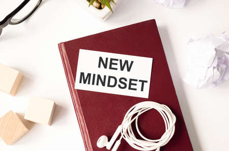 top view image of table with open notebook and the text new mindset new results. success and personal development conceptの写真素材
