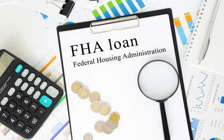Paper with FHA loan on a table with pen and magnifierの写真素材