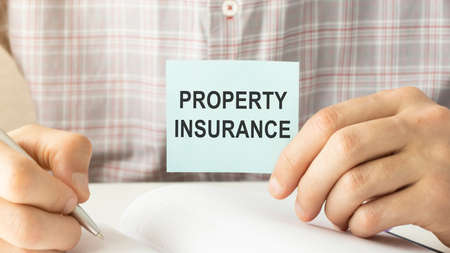 Businessman holding a card with text Renter's insuranceの写真素材