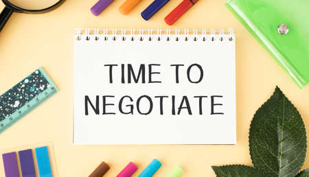 Time to negotiate on a notebook with a cup of coffee, compressed sheets, crayons, staplerの写真素材