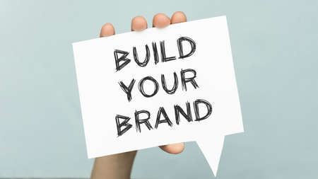 marker pens and note paper written build your brand over white backgroundの写真素材