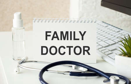 On a purple background a stethoscope with yellow list for you text FAMILY DOCTORの写真素材