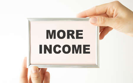 Handwriting text writing More Income. Concept meaning Additional money receives for an exchange of good or services Male human wear formal work suit presenting presentation using smart device.の写真素材