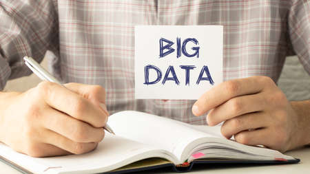 Big data text on a map in the hands of an office worker.の写真素材