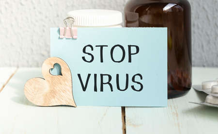 Text Stop Virus with thermometer and test tube on white backgroundの写真素材