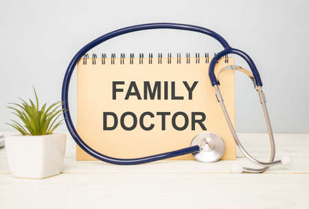 On a purple background a stethoscope with yellow list for you text FAMILY DOCTORの写真素材