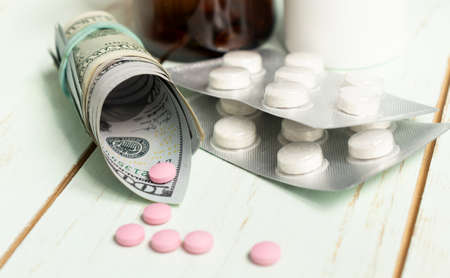 Wallet With US Dollar Cash And Medication On Wood Backgroundの写真素材
