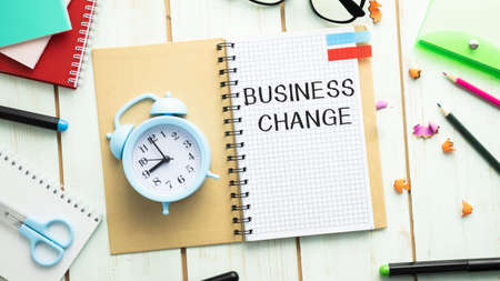 text CHANGED BUSINESS written on notepad lying on office desk, business conceptの写真素材