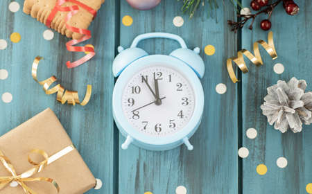 Clock. Christmas wooden background. New Year's holiday. Christmas motive. On a wooden surface. Top view. Free space for your text.の写真素材