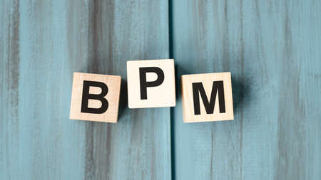 Acronym BPM made with wooden blocks on light background.の写真素材
