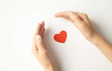 Cropped view of hand with red heart isolated on white background