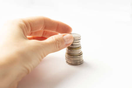 Close up of male hand holding silver coin isolated on white background, financial concept